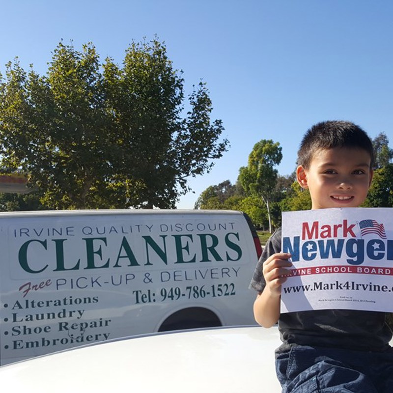 My son showing appreciation to Irvine Quality Discount Cleaners to be the first business to hang our signs.