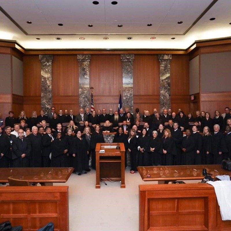 I am in the back row in front of the US flag with other JPs at the Texas Supreme Court.